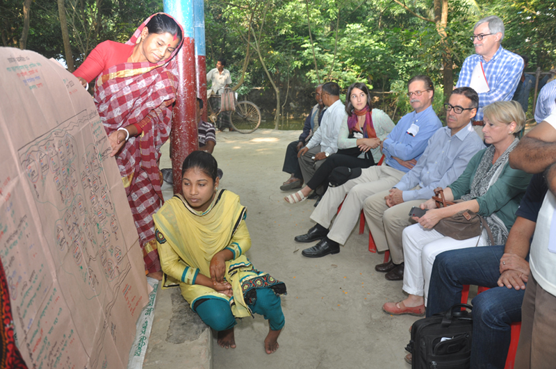 Locals from a HYSAWA project area explaining the purpose and use of social map to a visiting Swiss delegation